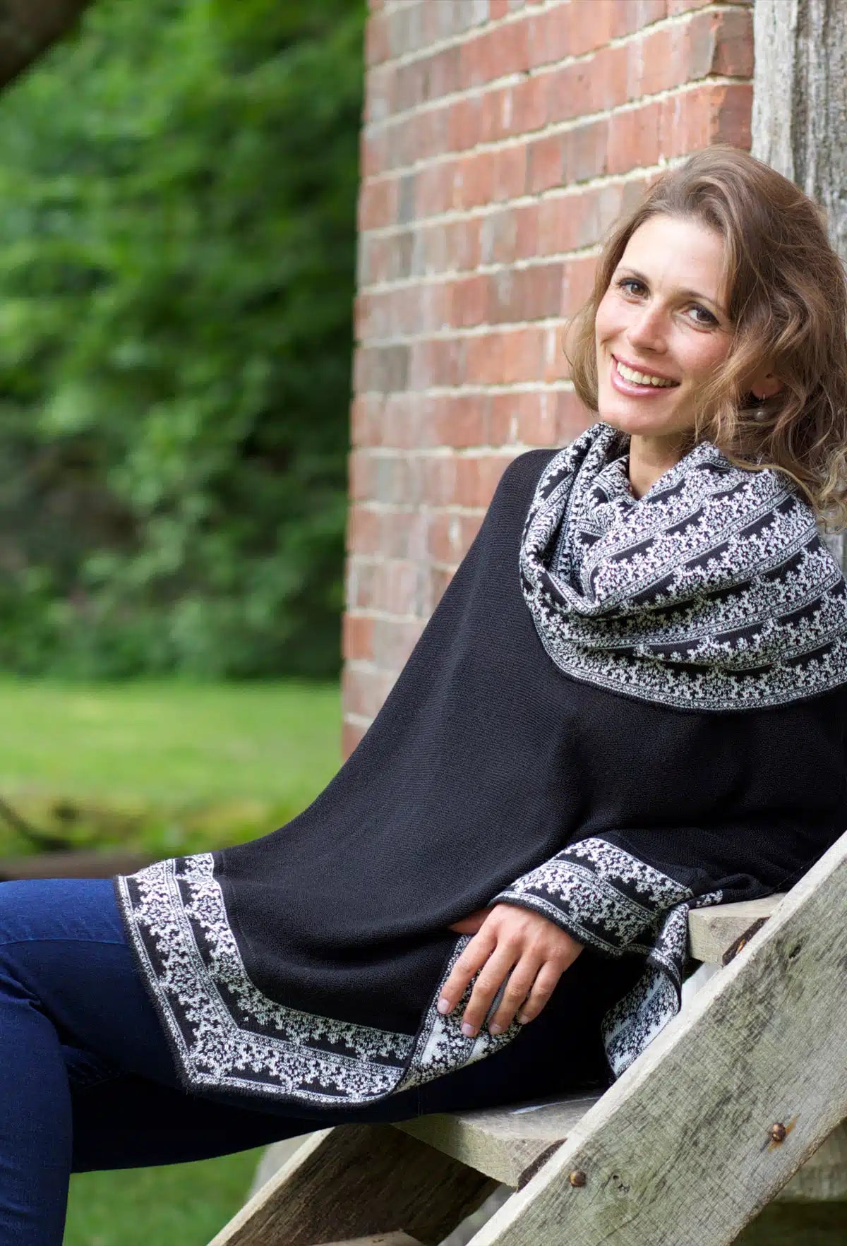 Womens elegant black poncho with detailing