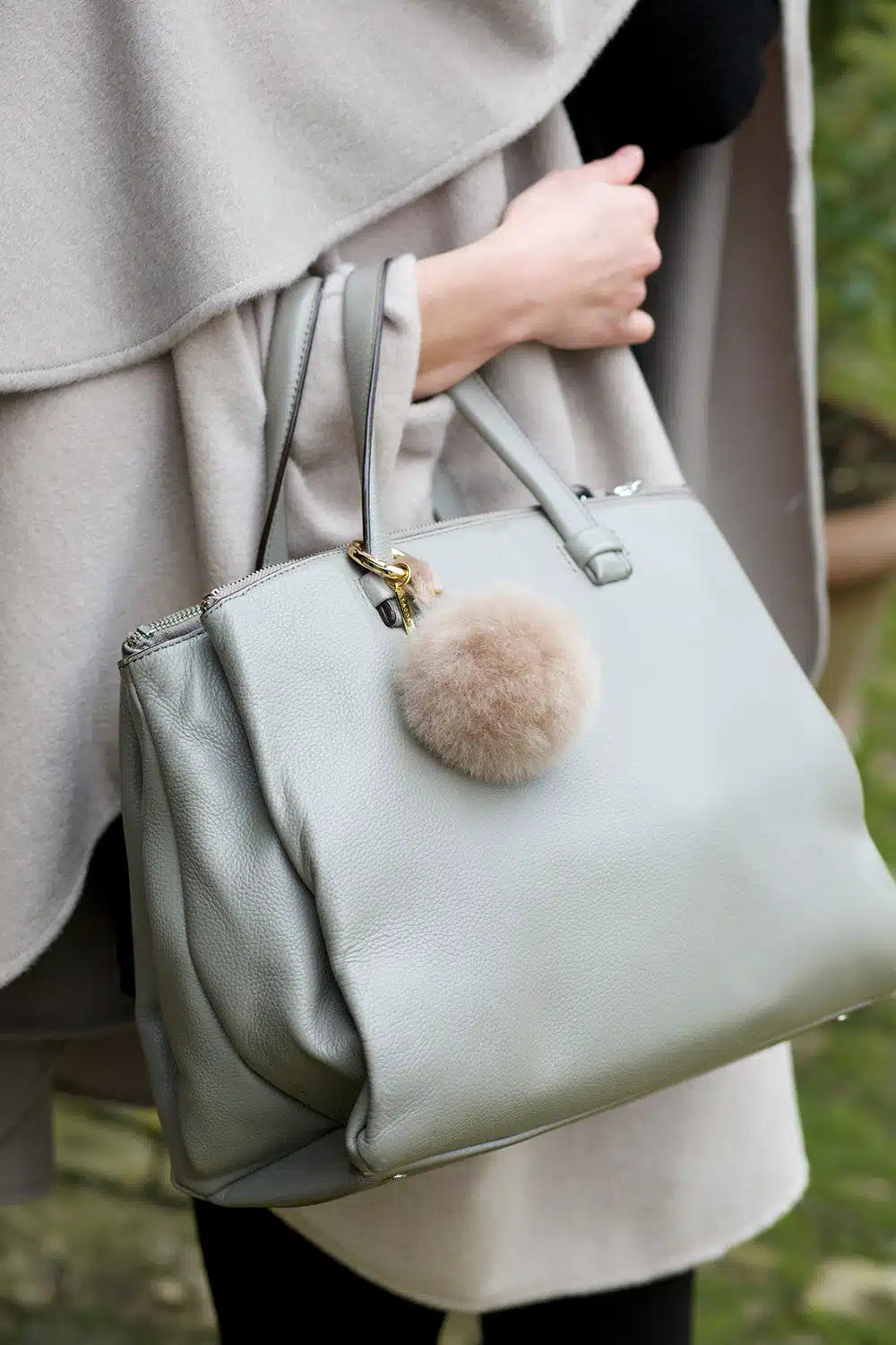 Lacorine alpaca fur pom pom keyring in taupe with a soft, fluffy texture, perfect as a stylish accessory for keys or bags.