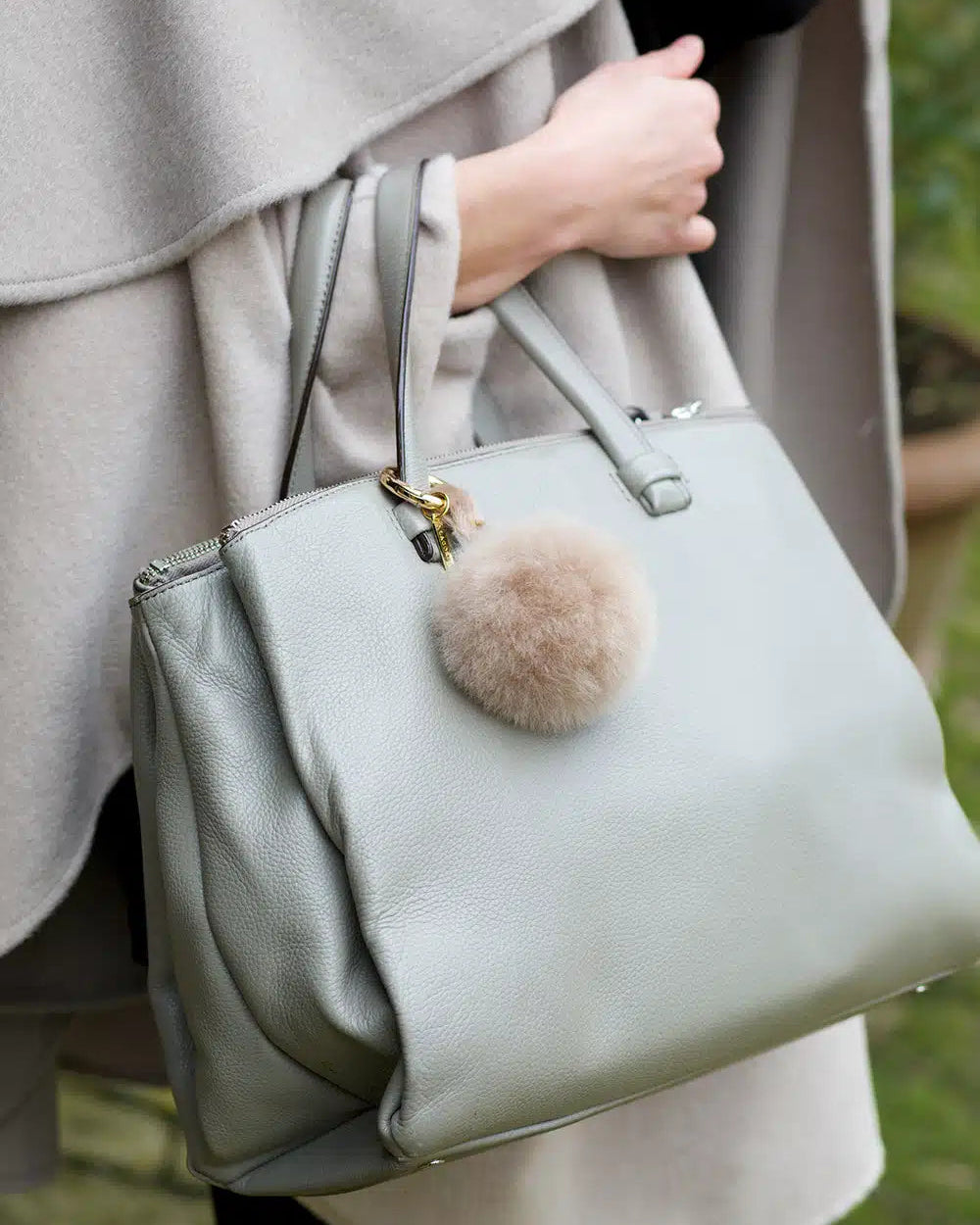 Lacorine alpaca fur pom pom keyring in taupe with a soft, fluffy texture, perfect as a stylish accessory for keys or bags.