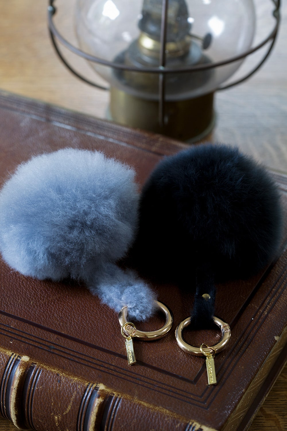 Lacorine alpaca fur pom pom keyring in mixed colors, stylish accessory with soft, fluffy fur and metal keyring attachment.