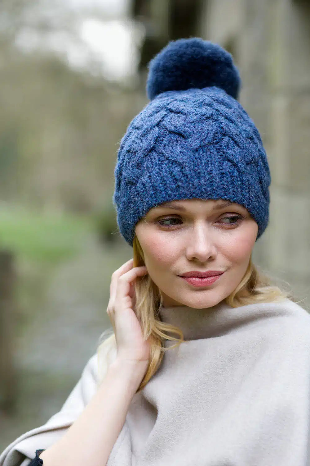 Navy blue Lacorine pom pom alpaca beanie hat with matching headband, soft and cozy winter accessory for warmth and style.