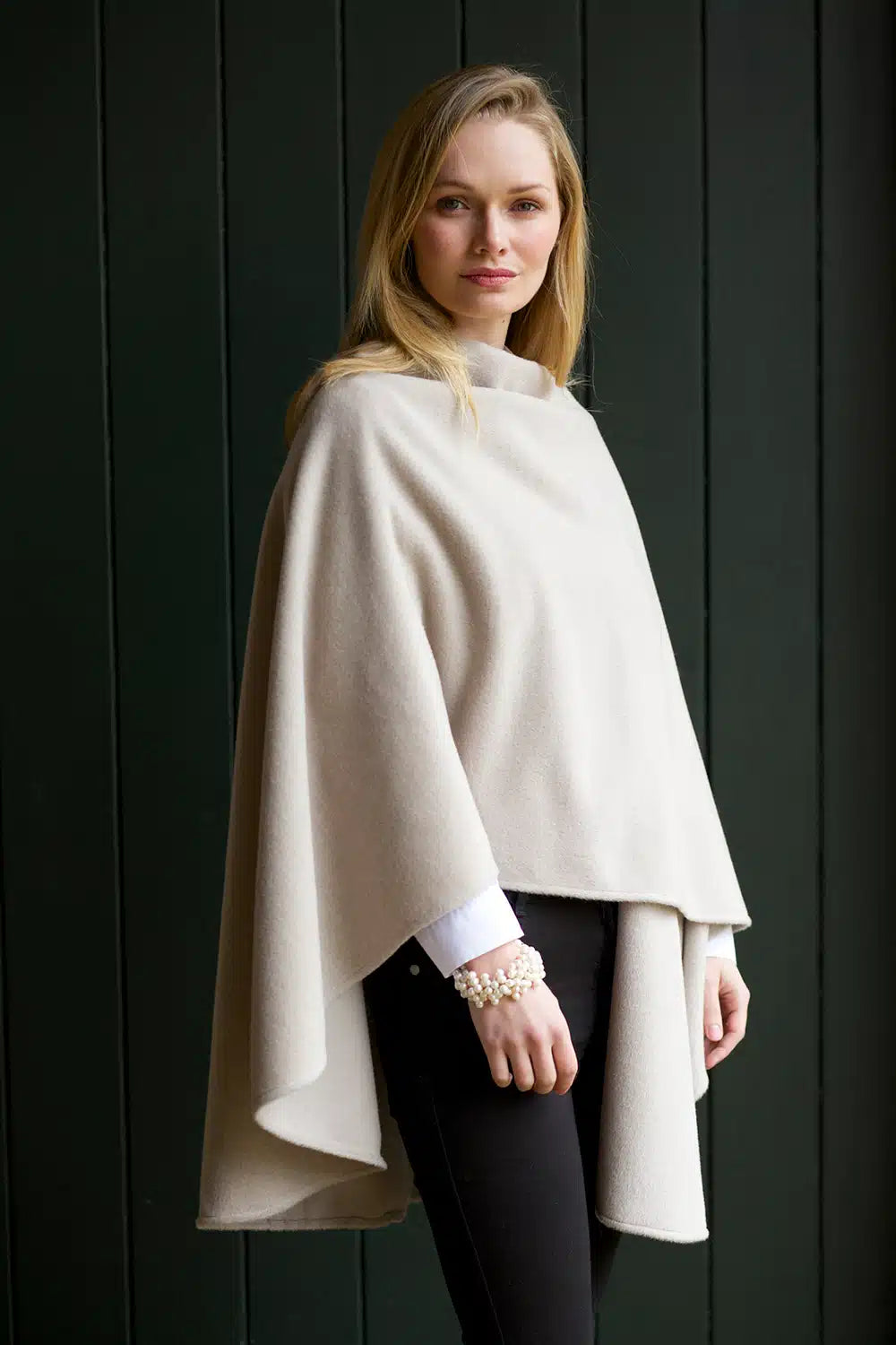 Lacorine classic alpaca wool cape in oyster color, draped over a mannequin showcasing its elegant, warm design.