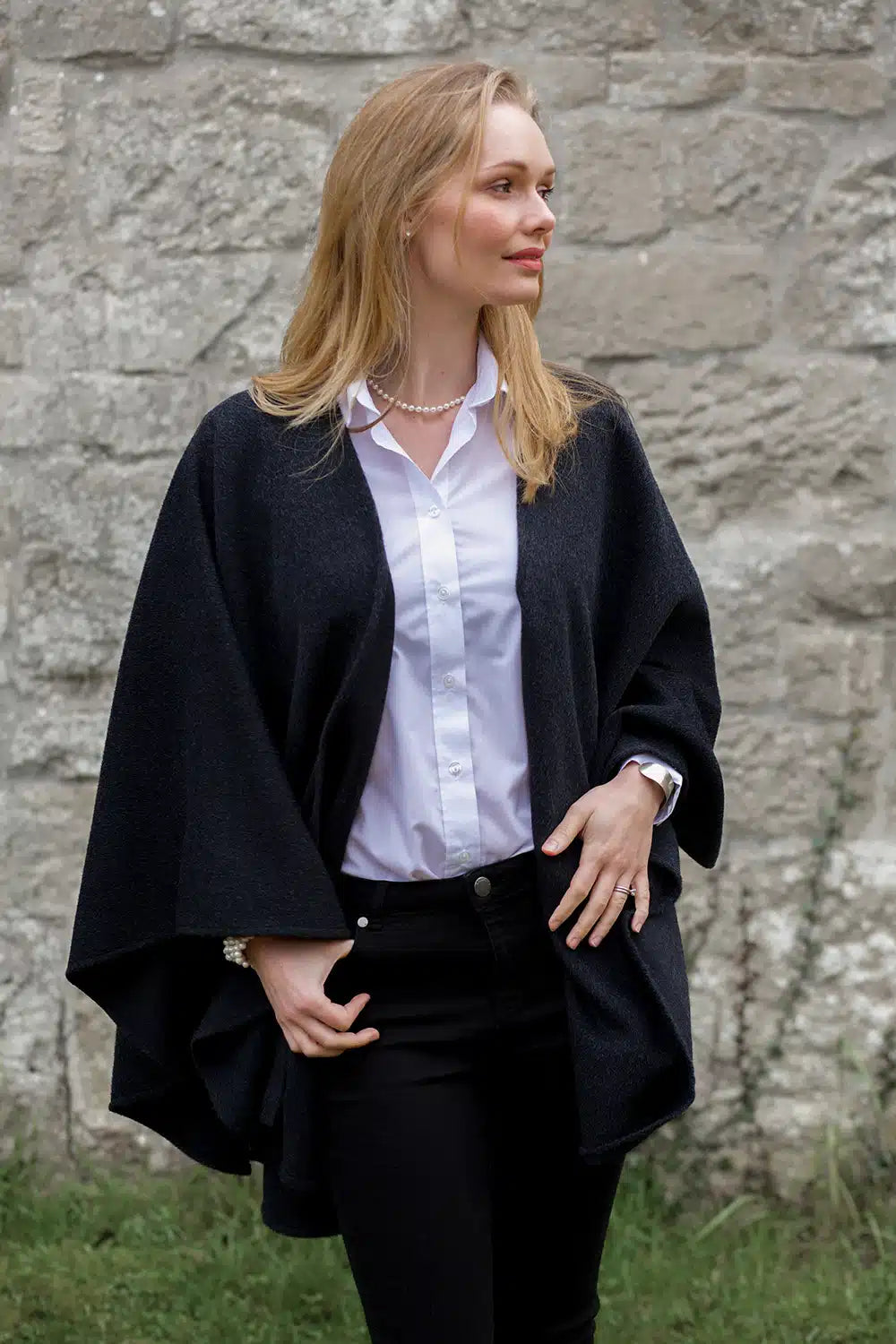 Lacorine classic alpaca wool cape in charcoal color, draped over a mannequin showcasing its warm, cozy design and textured fabric.