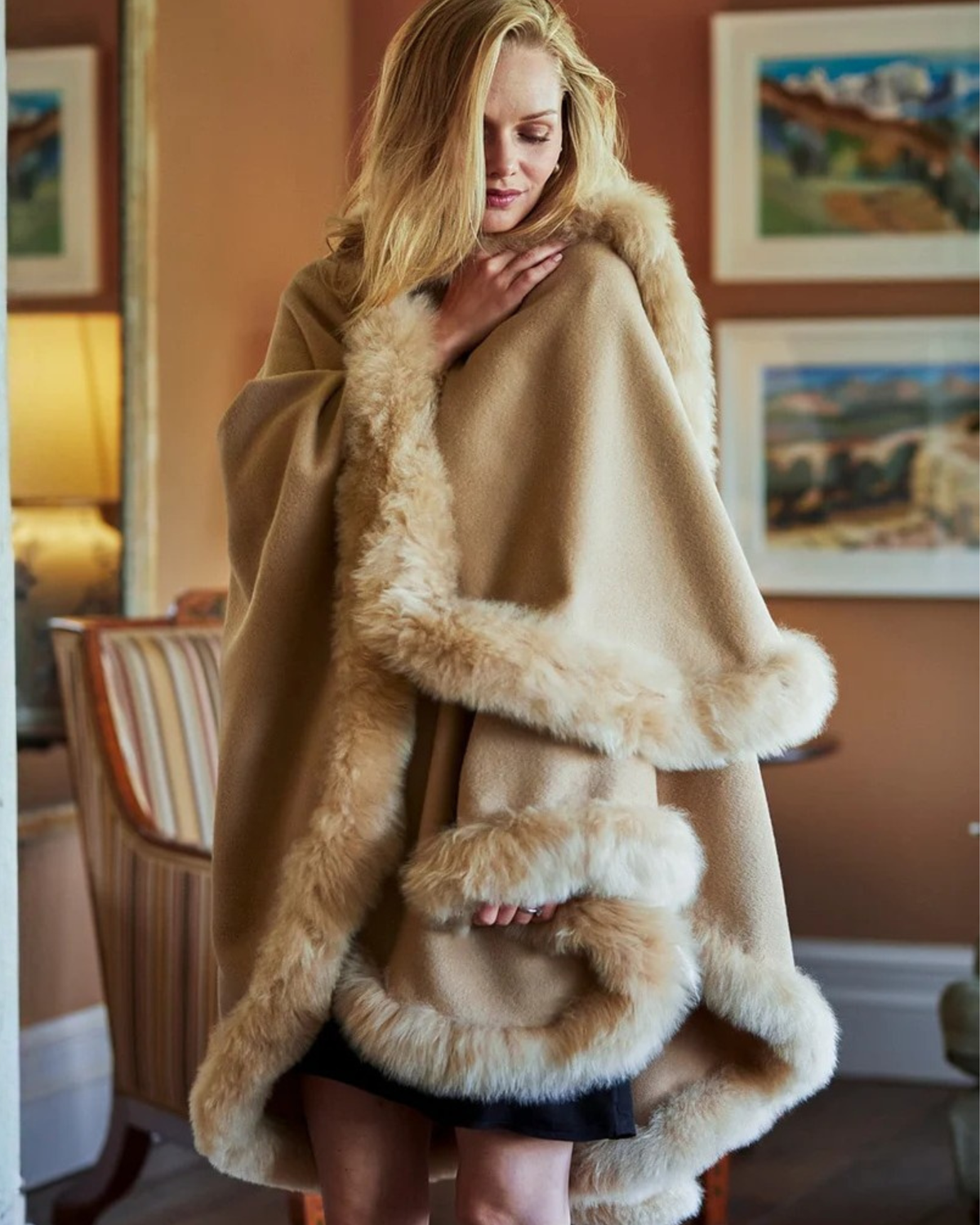 Lacorine Annabelle fur-trimmed alpaca cape draped over a mannequin, showcasing soft alpaca fabric and elegant fur detailing.