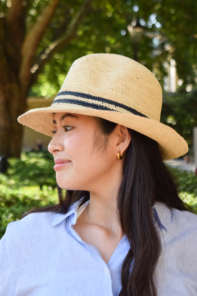 Lacorine unisex Panama hat with a classic trilby style, shown from a side profile, made of woven straw material.