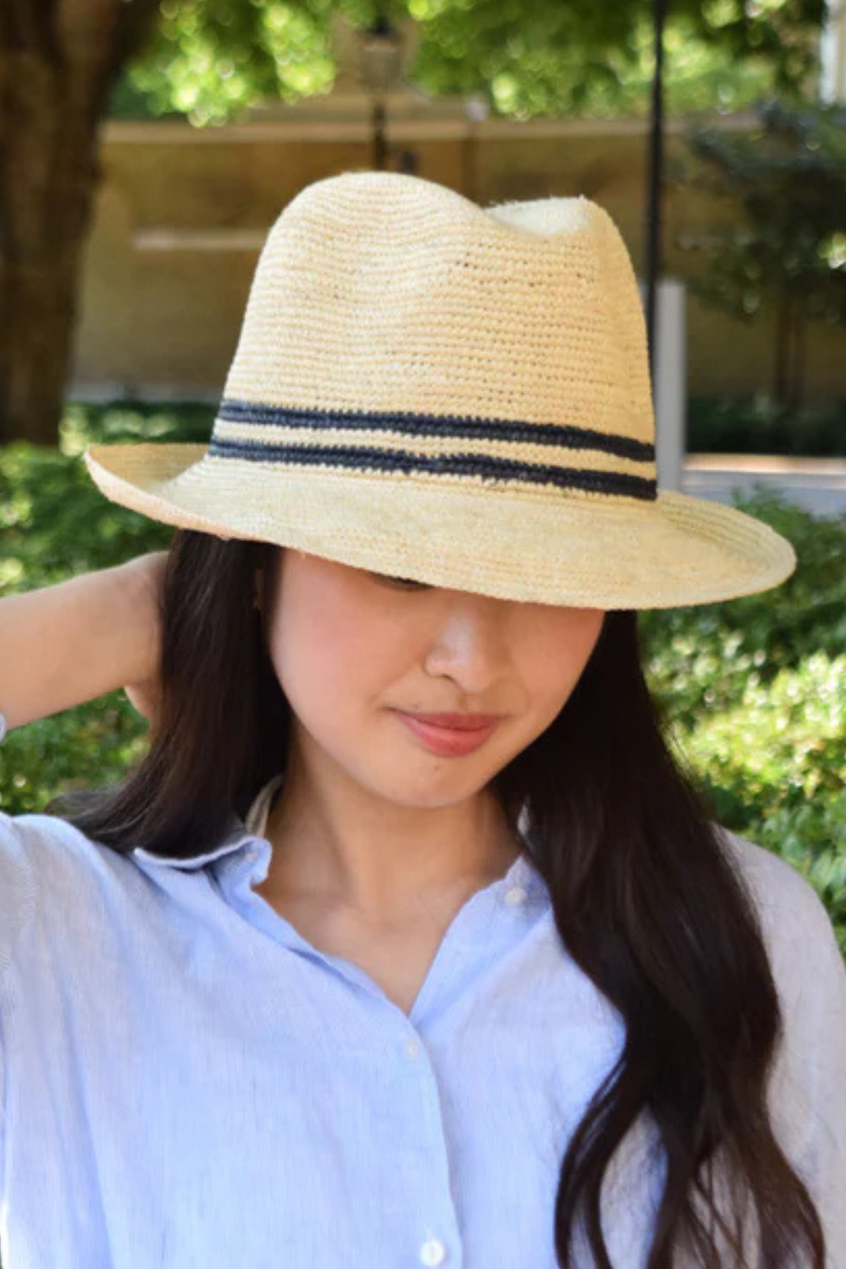Lacorine Trilby Panama Hat made of straw with a wide brim and black band, stylish accessory for sunny weather.