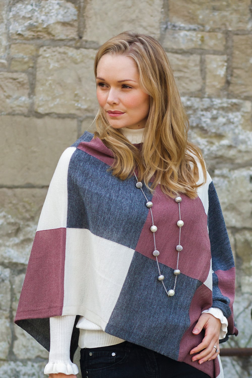 Lacorine Portofino alpaca poncho draped over a mannequin, showcasing soft beige fabric and cozy, stylish design.