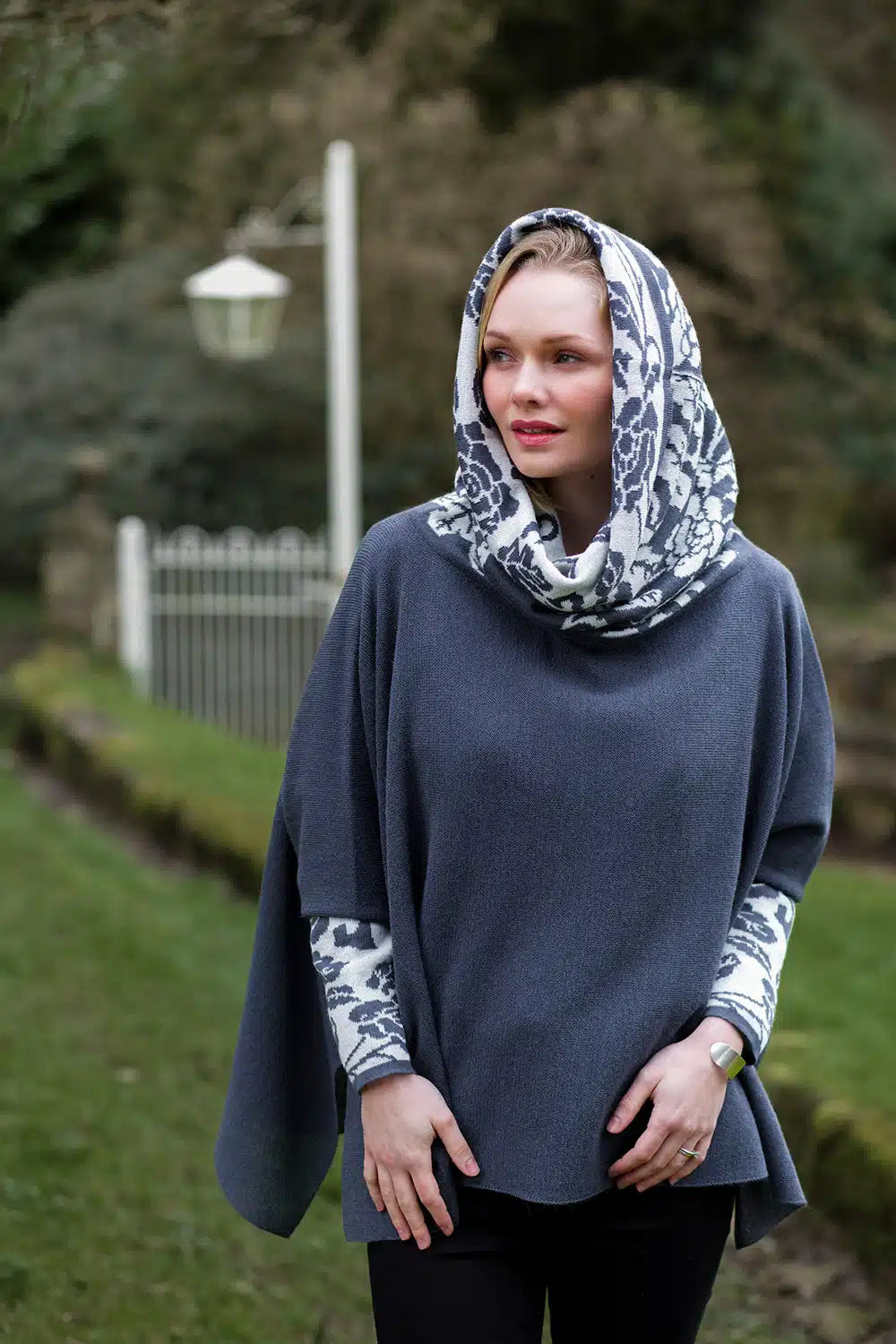 Lacorine Primavera alpaca wool poncho in grey and white, featuring cozy, stylish knit fabric and a relaxed fit for warmth and comfort.