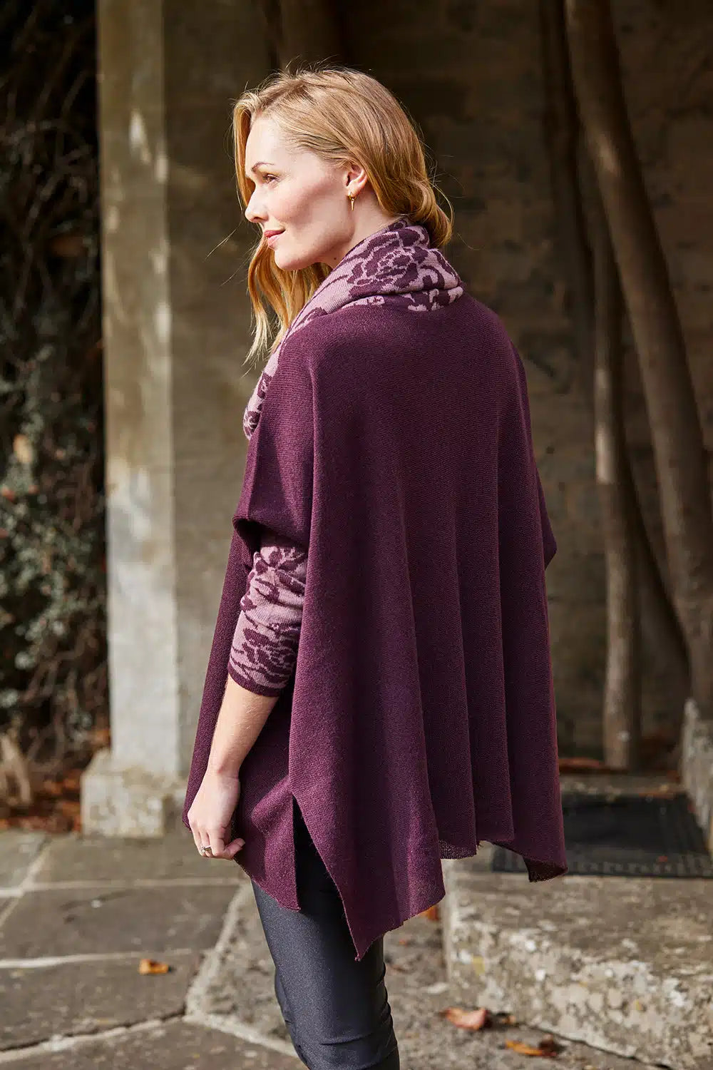 Lacorine Primavera alpaca wool poncho in dusty lilac and aubergine colors, draped to showcase its cozy, stylish design.