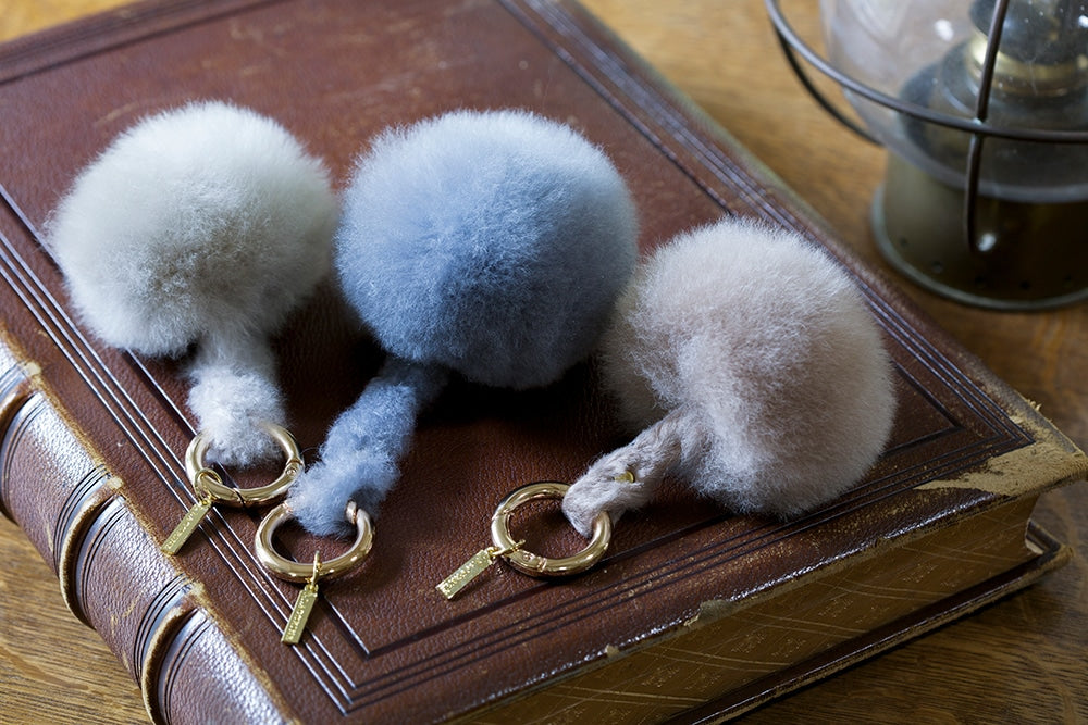 Lacorine alpaca fur pom pom keyring in mixed colors, soft and fluffy accessory for keys or bags.