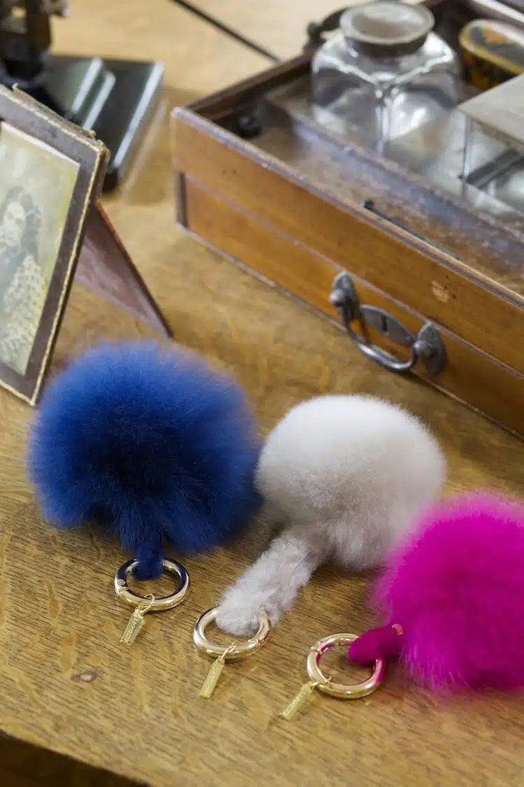 Lacorine alpaca fur pom pom keyring featuring soft, fluffy fur and a metal keyring attachment, perfect as a stylish accessory.