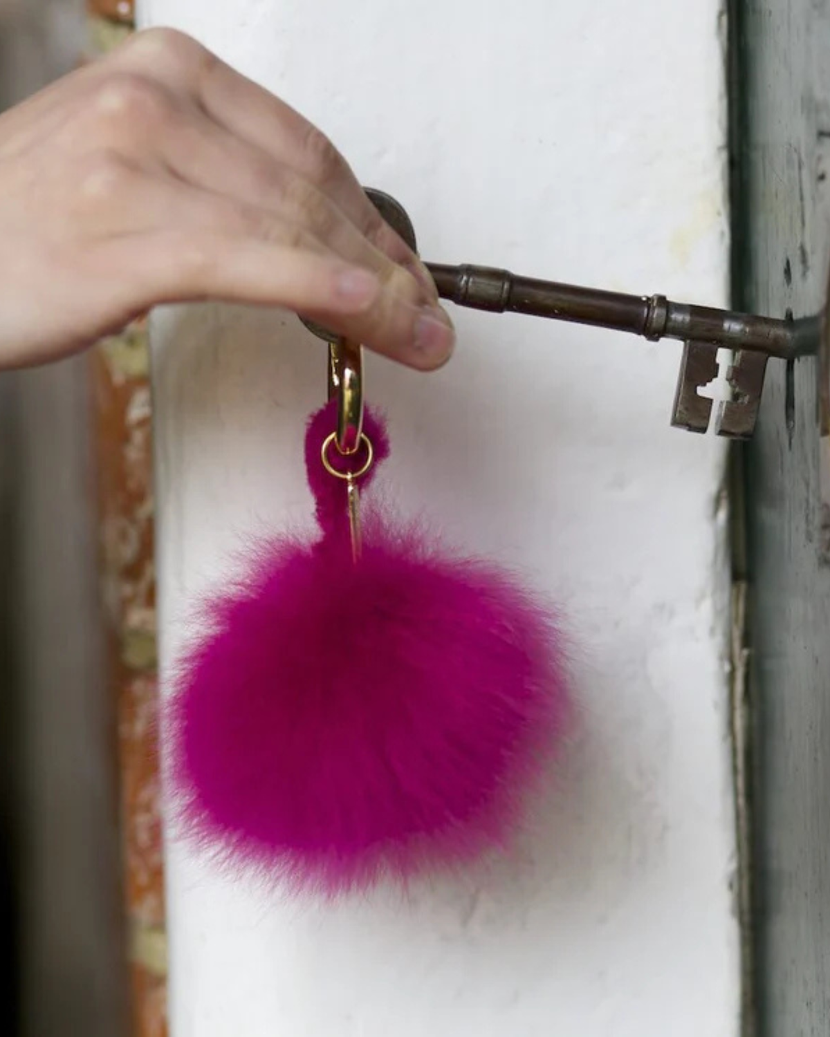 Lacorine alpaca fur pom pom keyring featuring a soft, fluffy beige fur ball accessory for keys or bags.