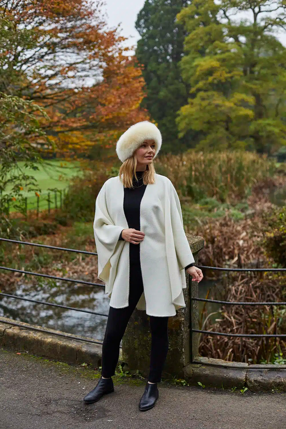 Cream Lacorine classic alpaca wool cape draped over a mannequin, showcasing its soft texture and elegant design.