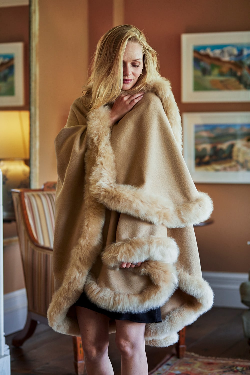 Camel-colored Annabelle fur-trimmed alpaca cape by Lacorine, showing the elegant wrap with plush fur collar and soft alpaca fabric.
