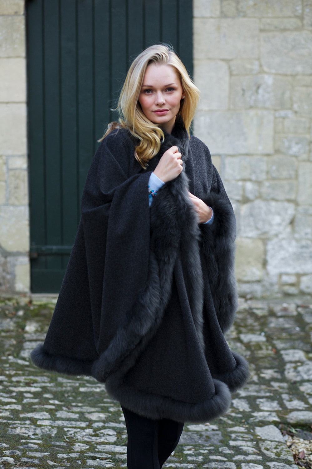 Charcoal Lacorine Annabelle fur-trimmed alpaca cape draped over a mannequin, showcasing luxurious cozy winter fashion.