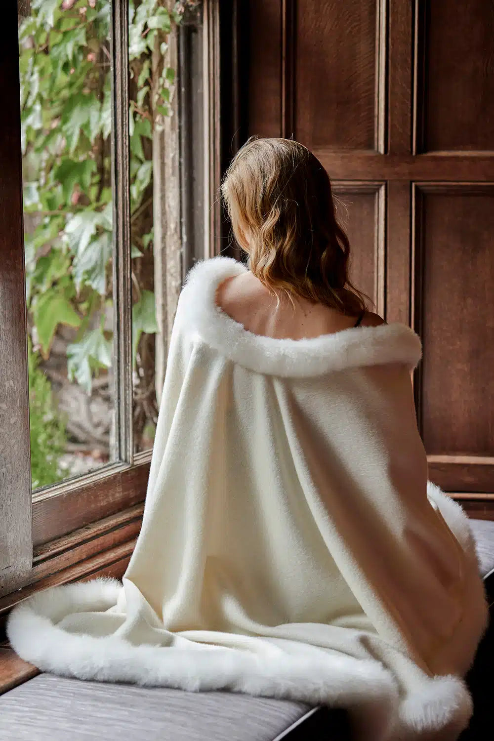 White Annabelle Fur Trimmed Alpaca Cape by Lacorine, showing its luxurious fur trim and cozy winter design.