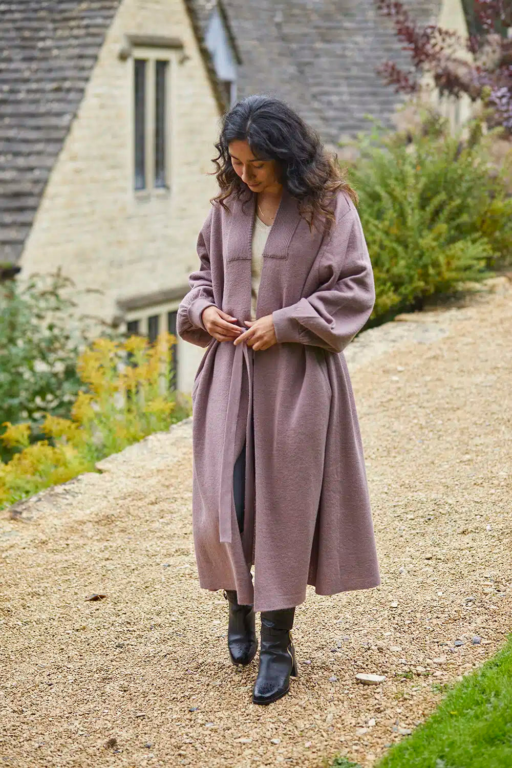Beige Lacorine Cecile Alpaca Cardigan displayed on a hanger, showcasing its soft knit texture and relaxed fit.