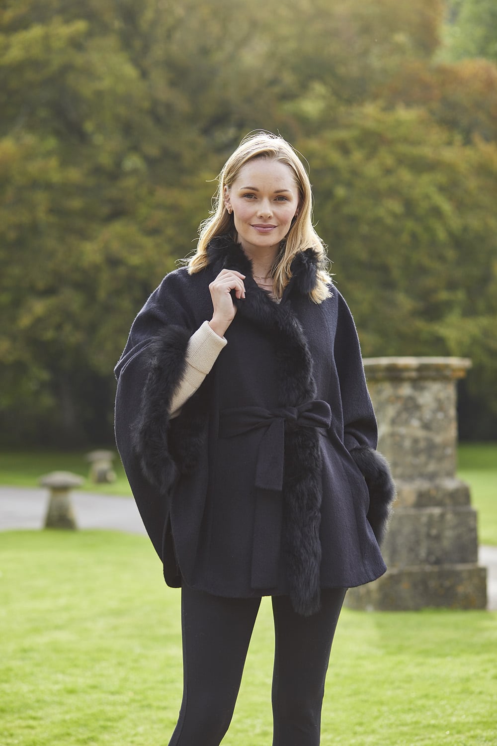 Black Lacorine alpaca coat with elegant fur trim, featuring a cozy and stylish design perfect for cold weather.