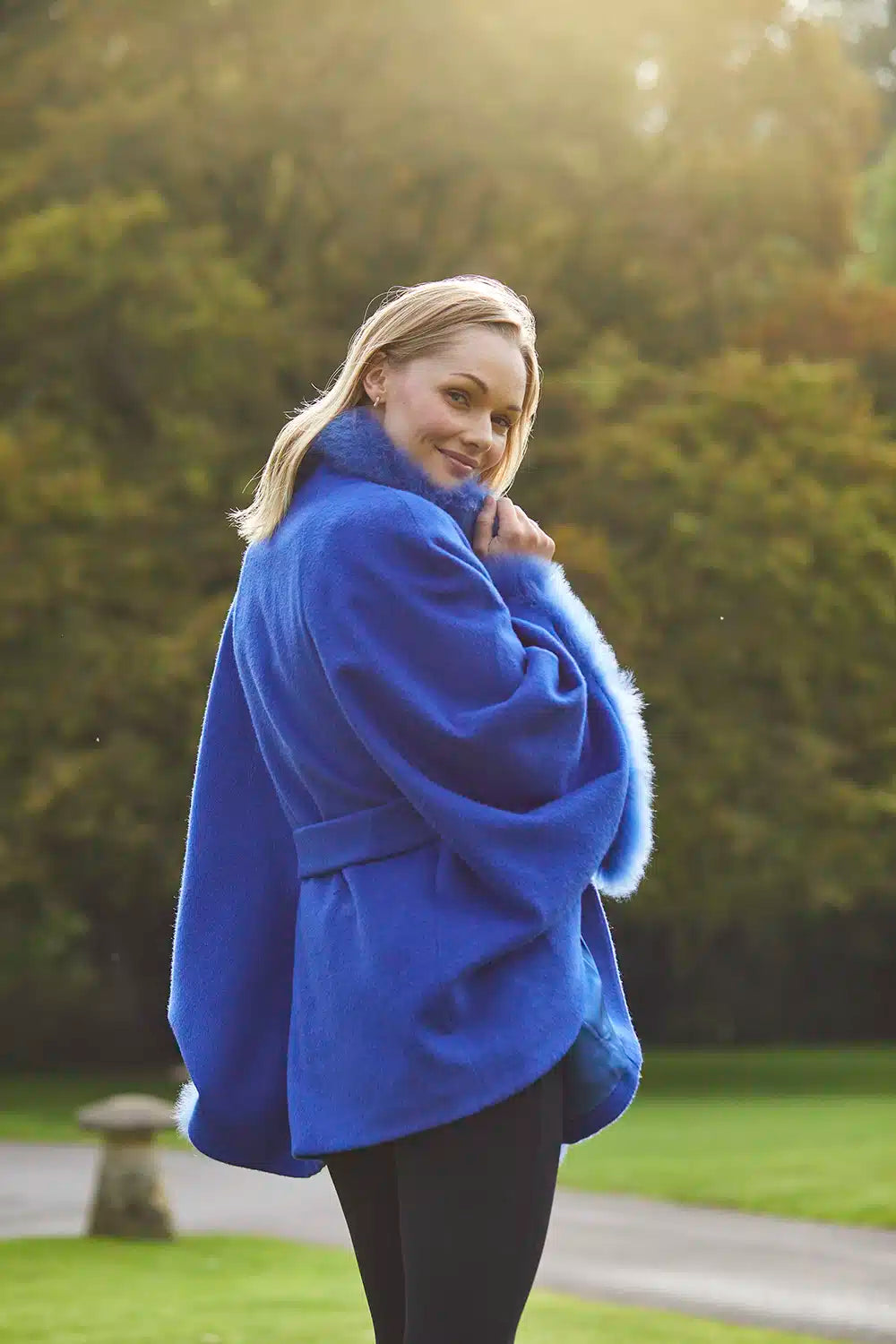 Lacorine Lucia fur-trimmed alpaca cape with elegant design, showcasing soft alpaca fabric and luxurious fur trim.
