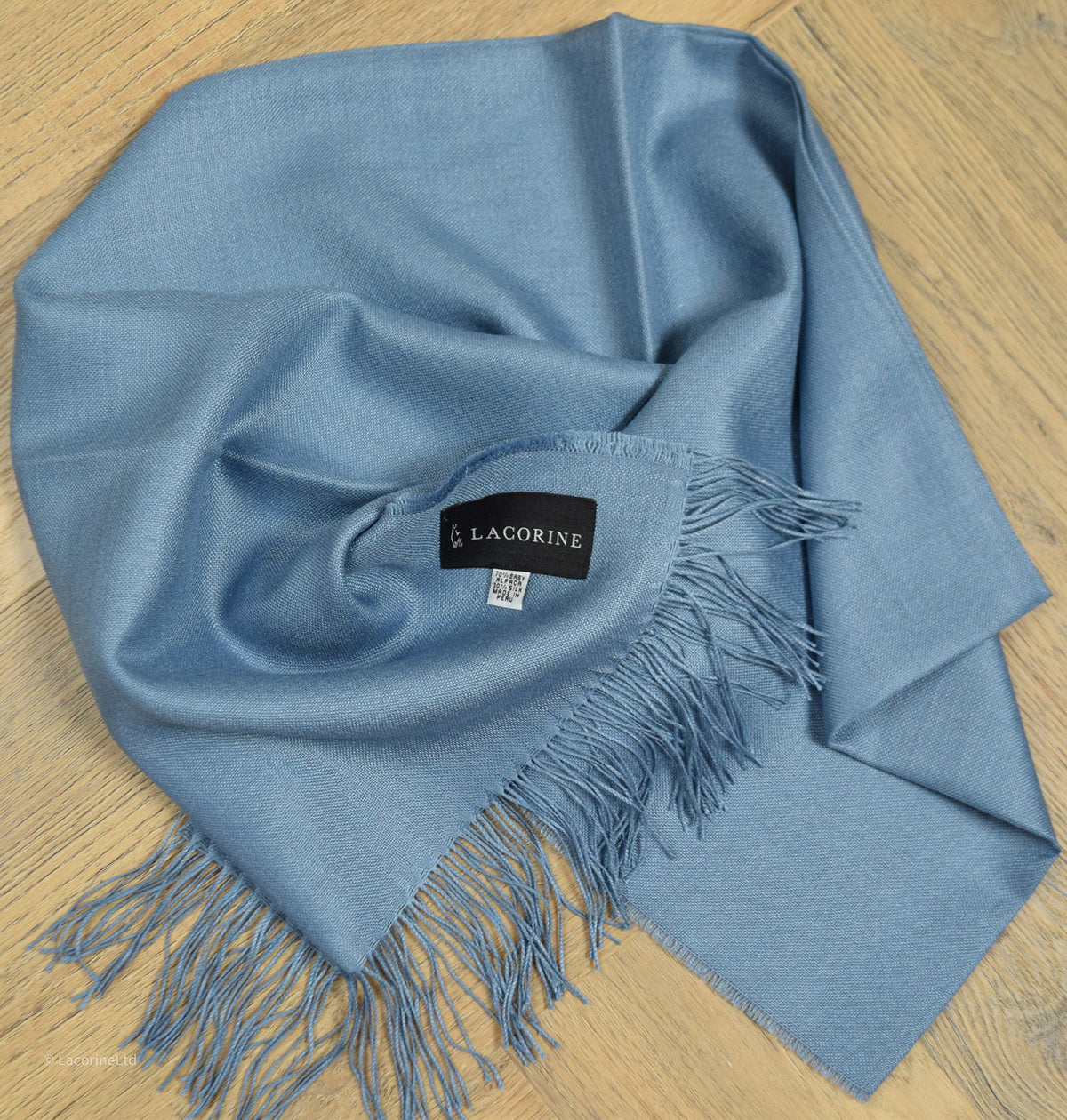 Light blue Lacorine signature pashmina knitwear featuring soft, luxurious alpaca fibers and intricate knit pattern.