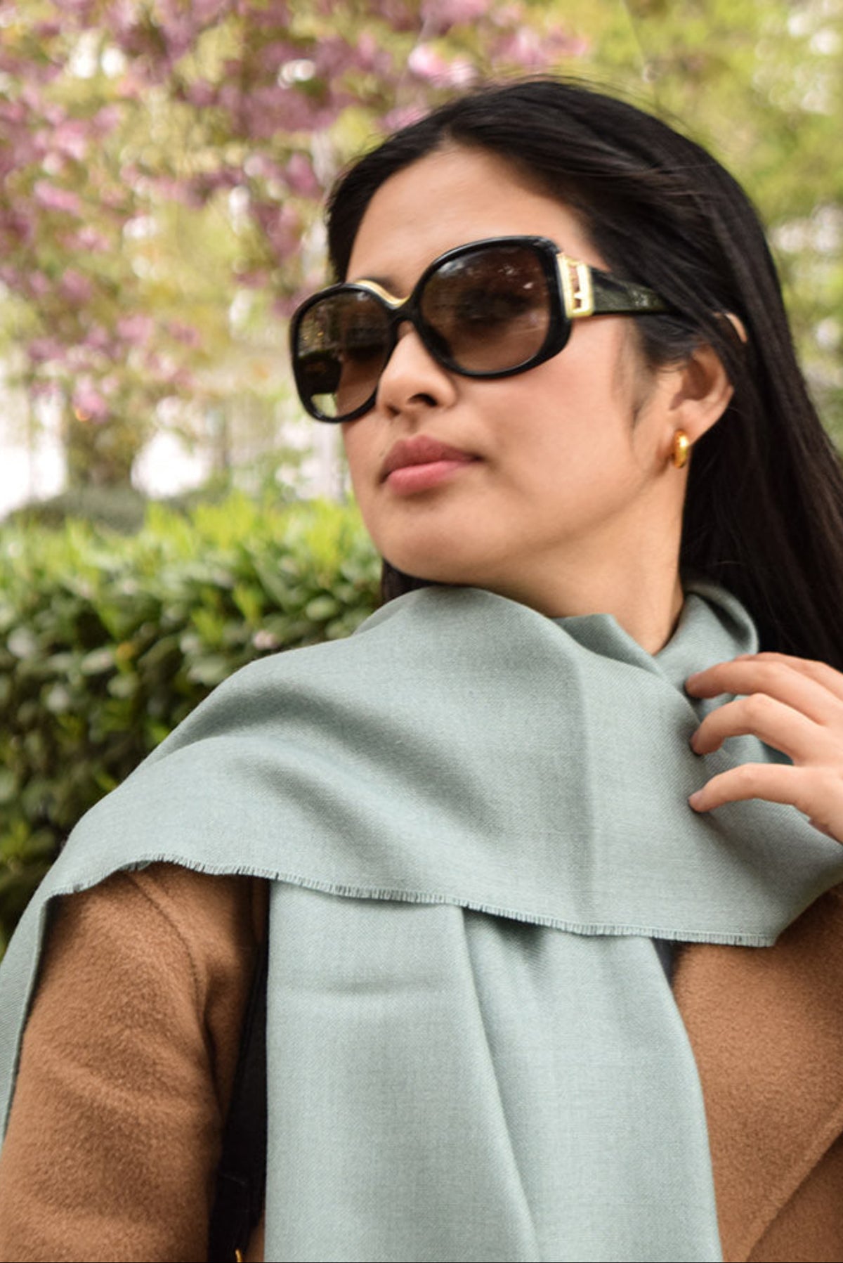 Frost green Lacorine Signature Pashmina knitwear draped over a model in a cozy lifestyle setting.