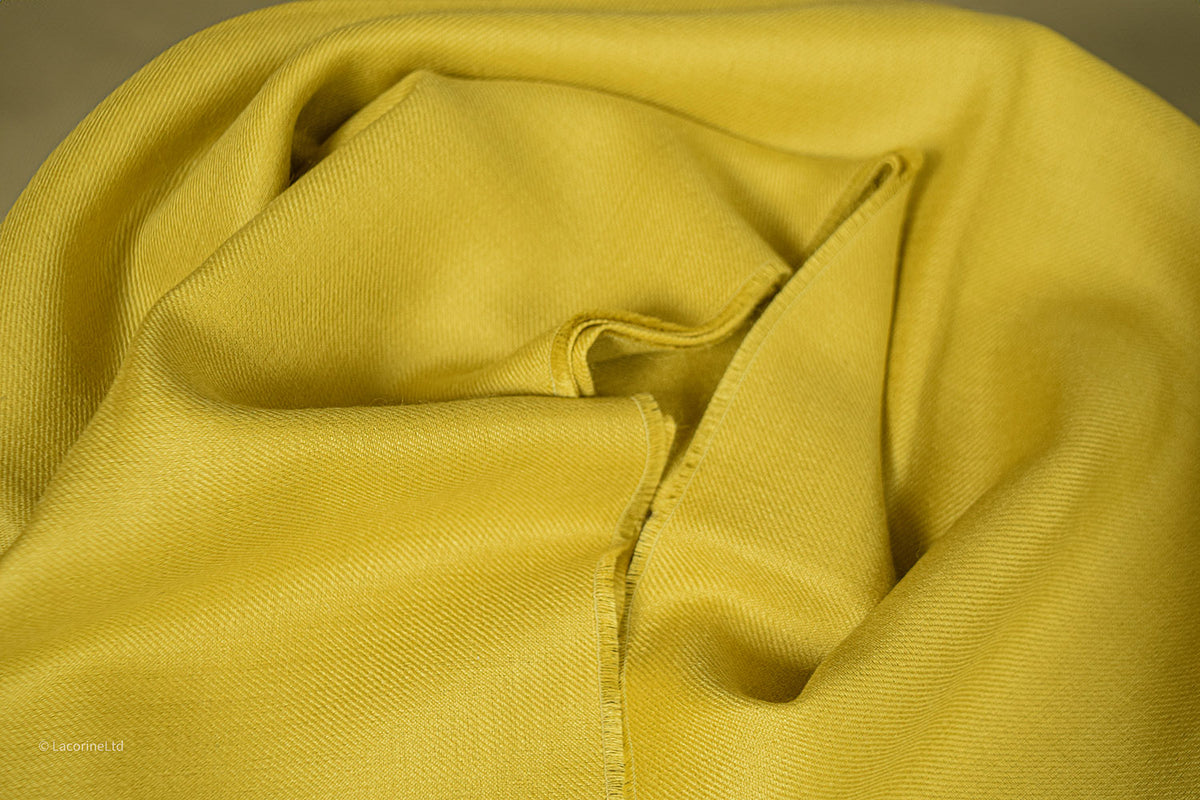 Close-up of yellow Lacorine Royal Alpaca Pashmina knitwear showing soft, fine knit texture and luxurious fabric details.