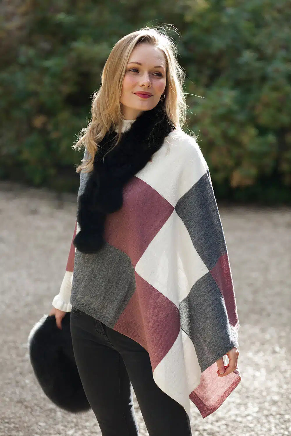 Lacorine Portofino alpaca poncho shown in beige with fringe edges, draped over a mannequin for a cozy, stylish look.