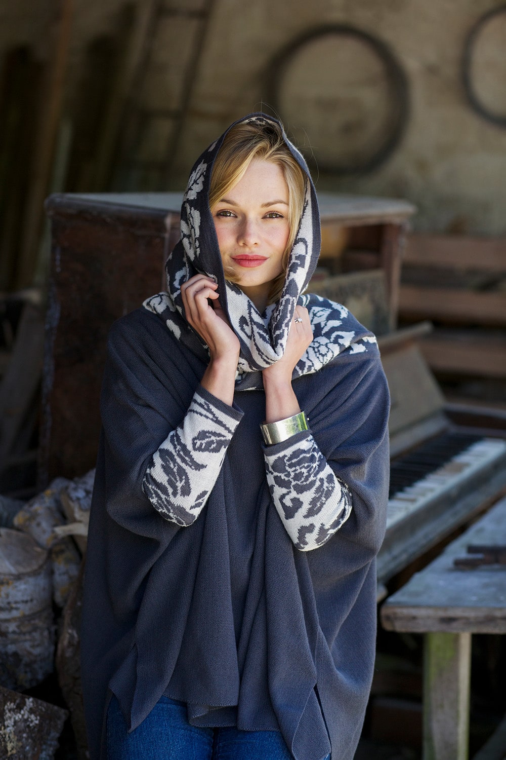 Lacorine Primavera alpaca wool poncho in grey and white, showcasing soft, cozy knit fabric and stylish draped design.