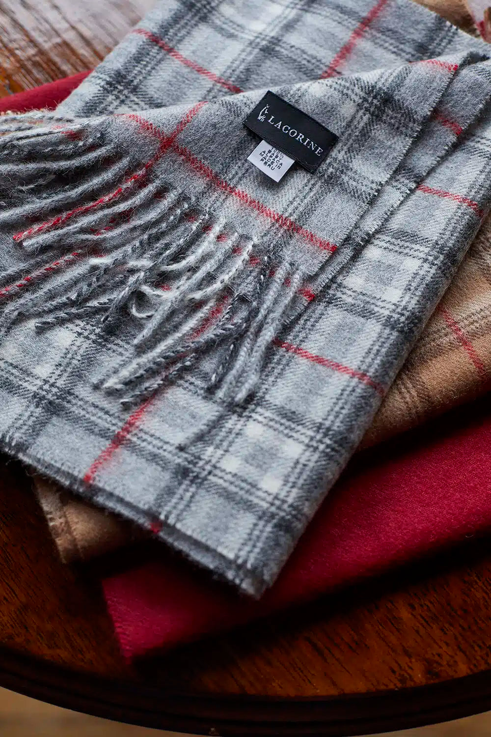 Grey and red check alpaca wool scarf by Lacorine, soft and warm accessory with a stylish plaid pattern.