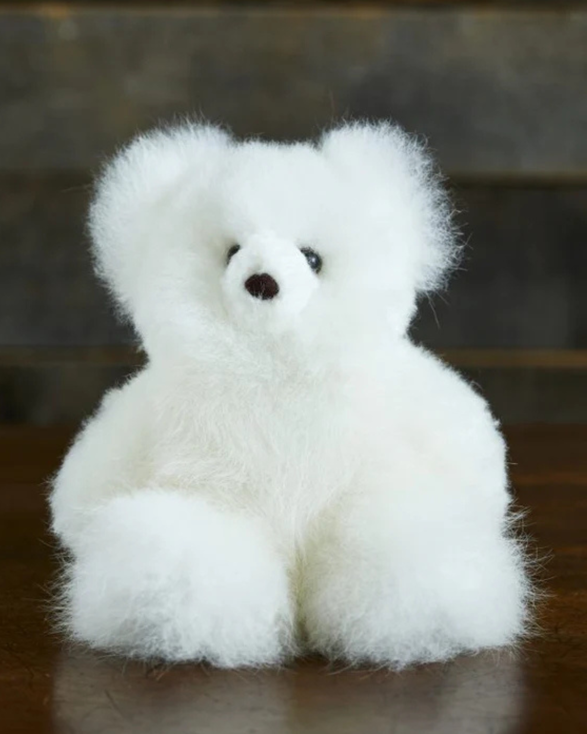 Small white alpaca fur teddy bear by Lacorine, soft plush toy with adorable, fluffy appearance perfect for cuddling.