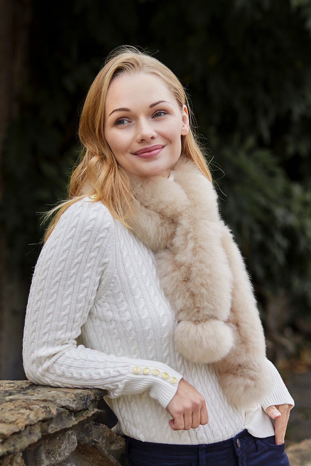 Oyster Twizzle alpaca fur scarf worn with a white cable-knit jumper